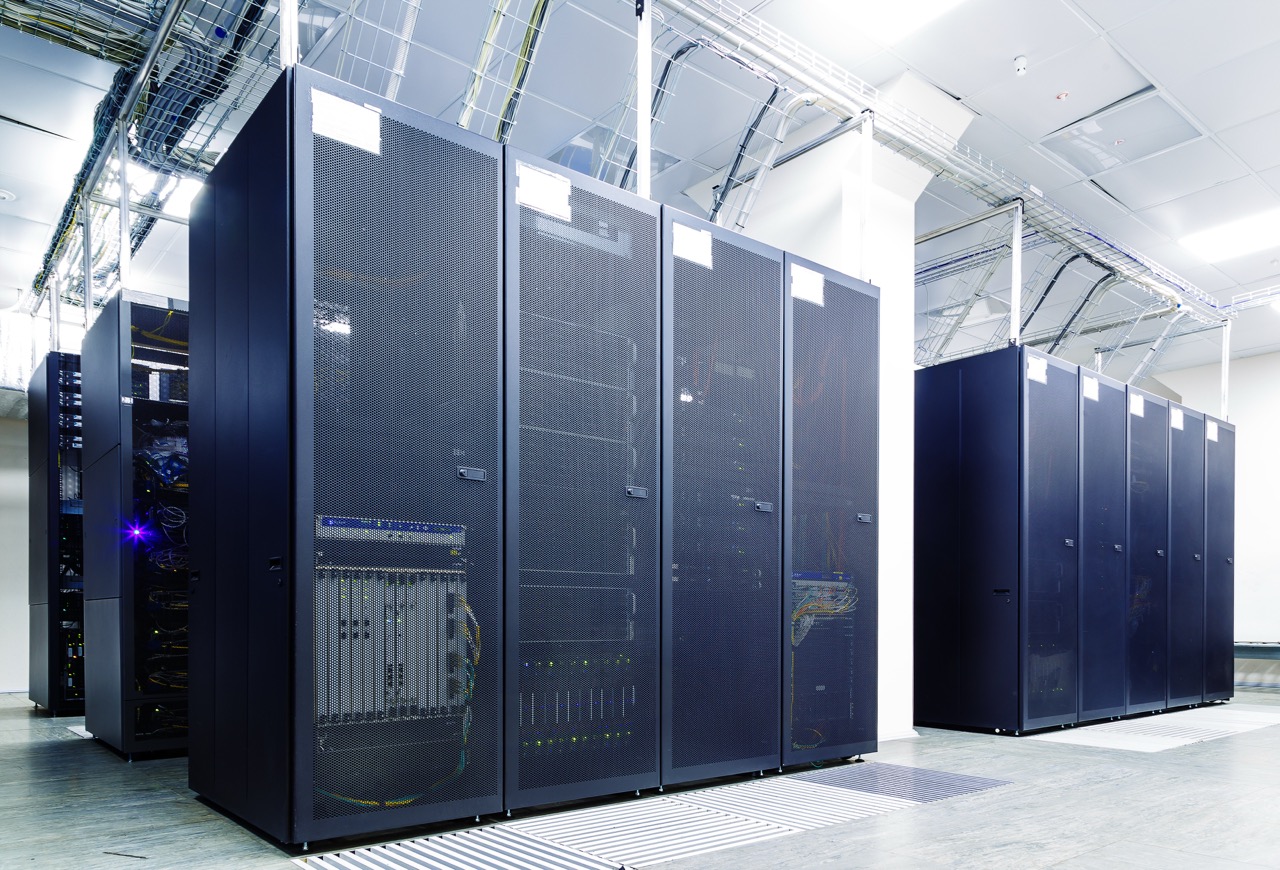 Room with rows of server hardware in the data center